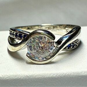 Round Cut Cubic Zirconia Solitaire With Infinity Band Of Blue Sapphire Crystals